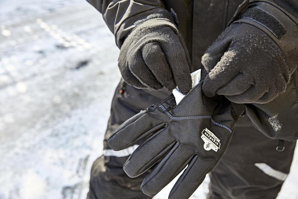 man putting hand warmer pack in glove