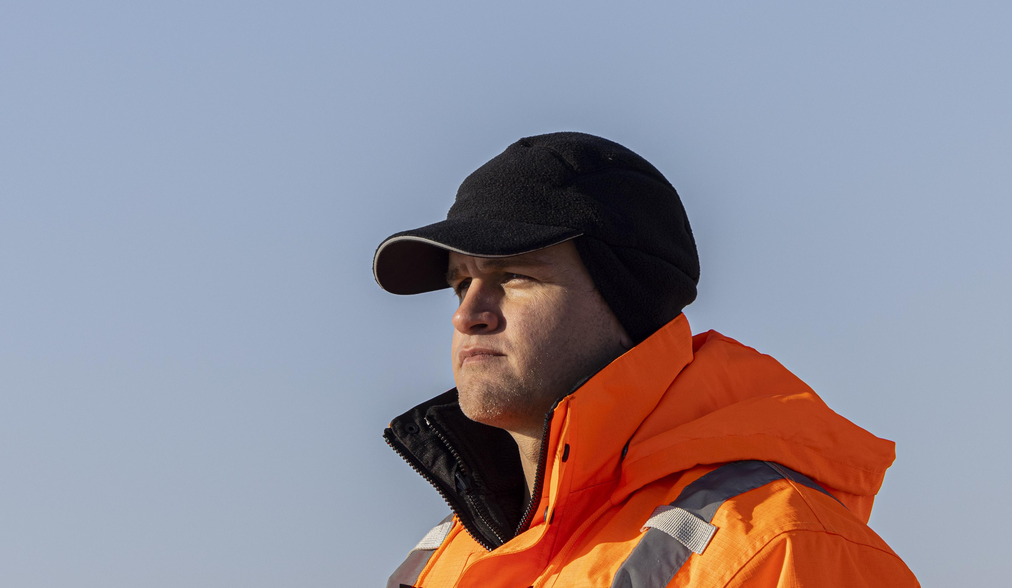 man wearing thermal baseball cap with earflaps