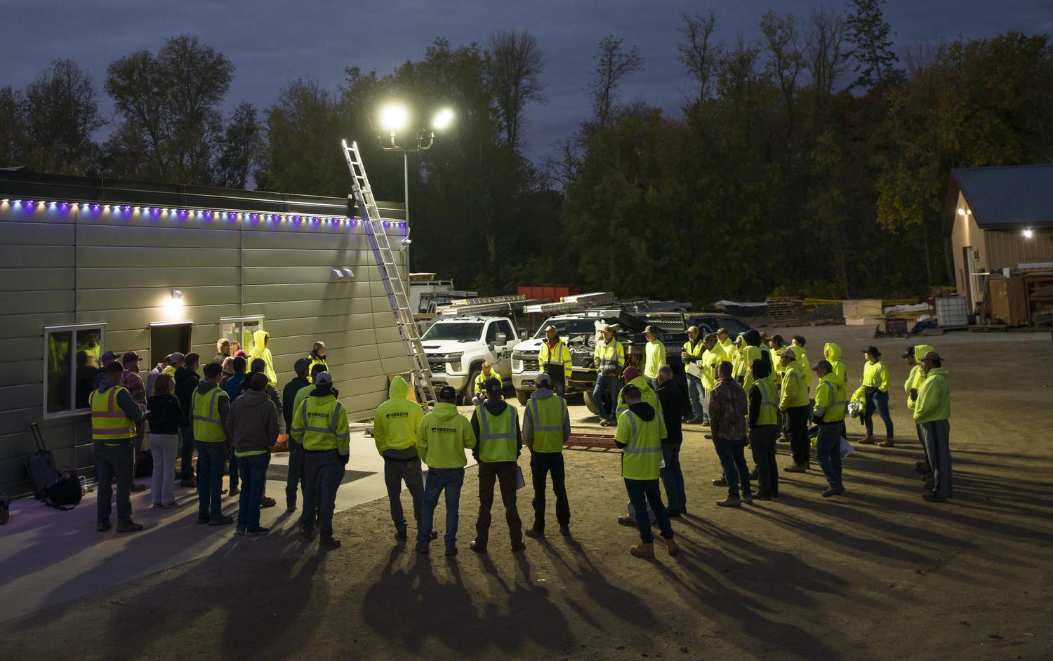 Herzog crew gathers for a pre-dawn toolbox talk on ladder safety