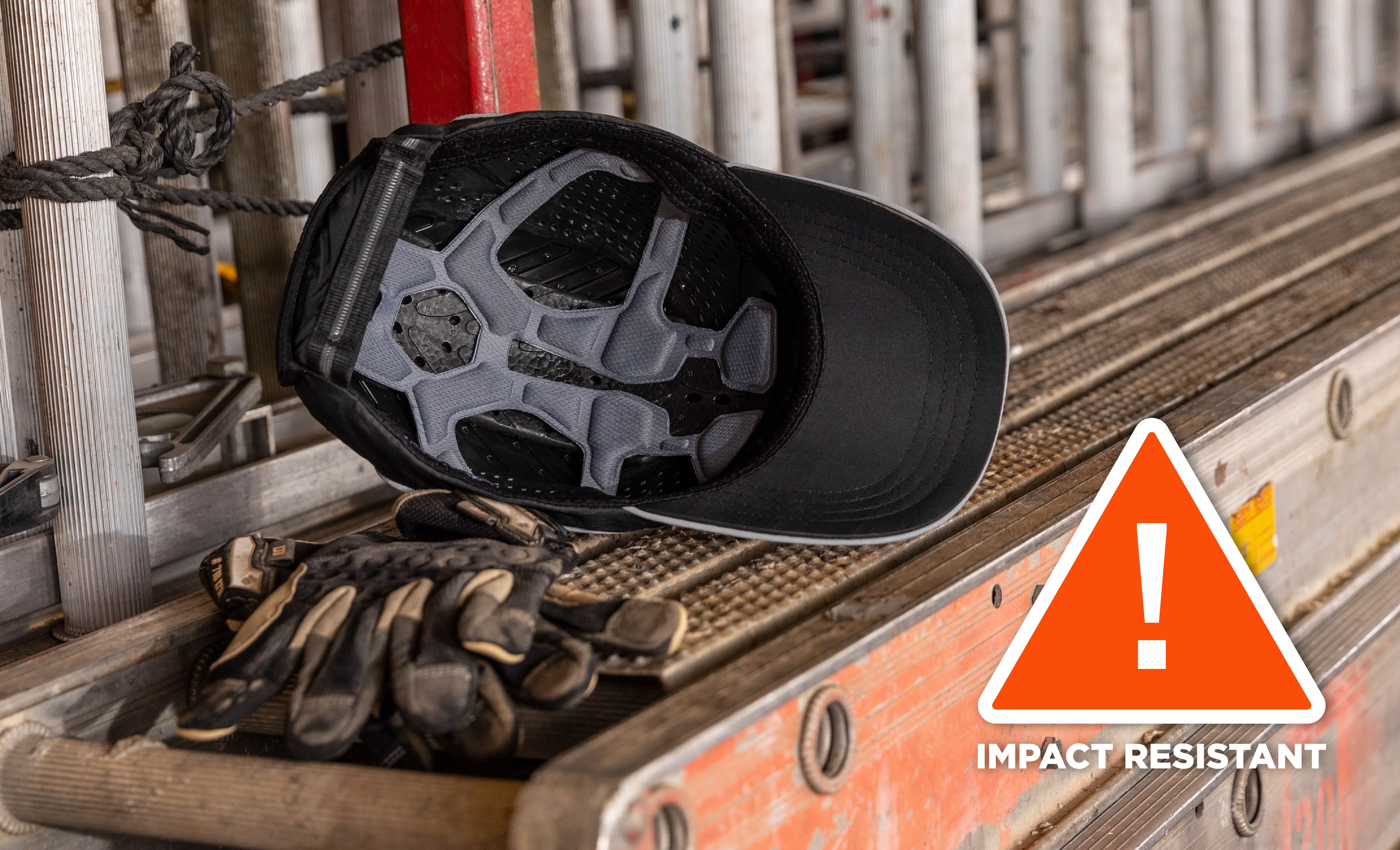 bump cap hat placed on a ladder. Badge that indicates this bump cap hat is impact resistant
