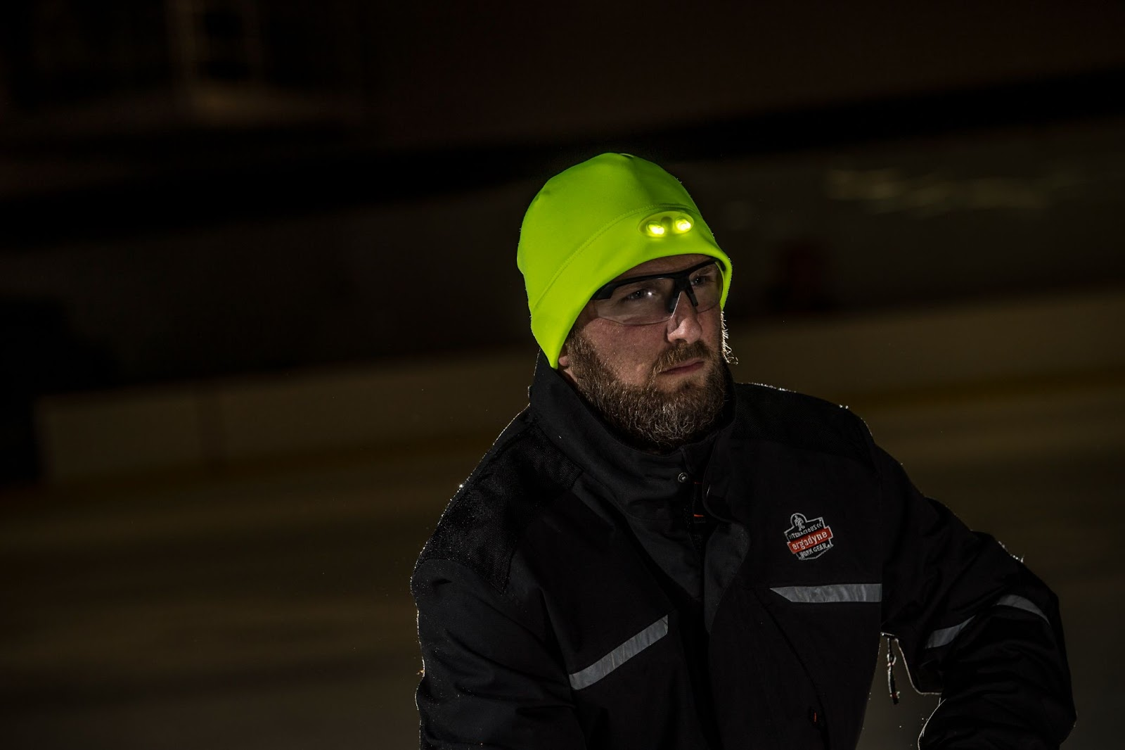 Worker wearing led beanie hat in cold outdoor setting at night