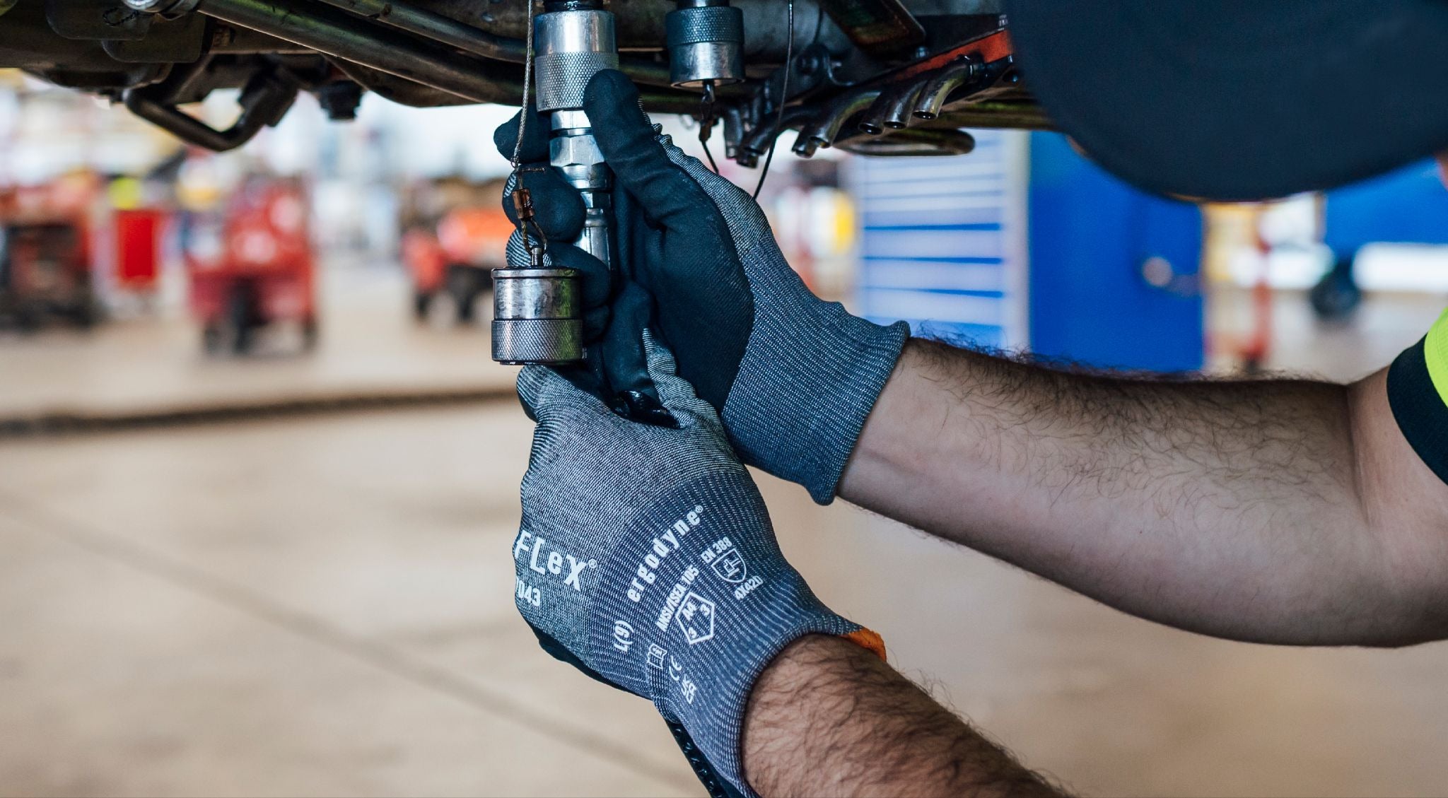 Car mechanic worker wearing a pair of 7043 cut resistant gloves while on the job