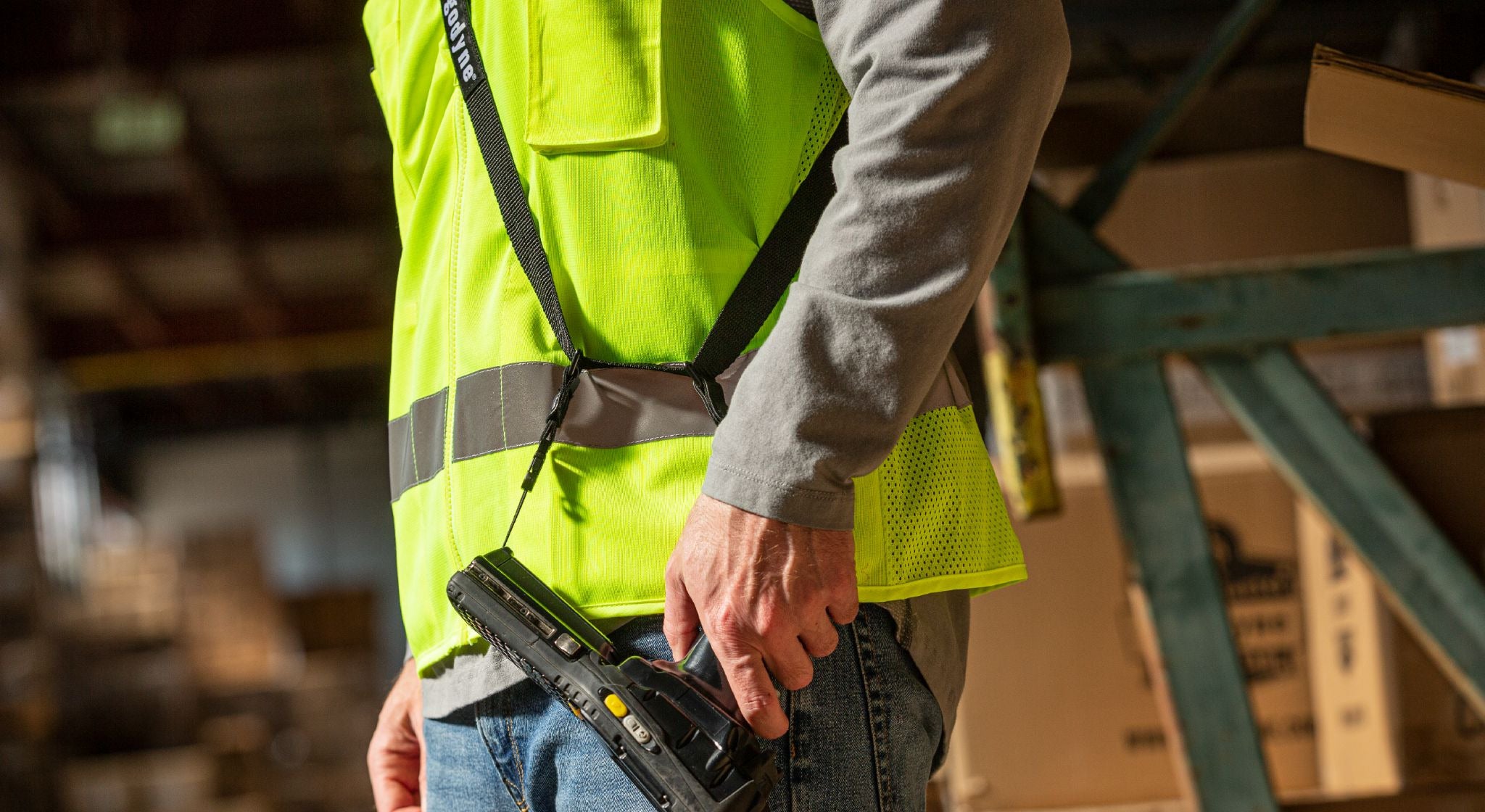 Worker in warehouse wearing a scanner sling