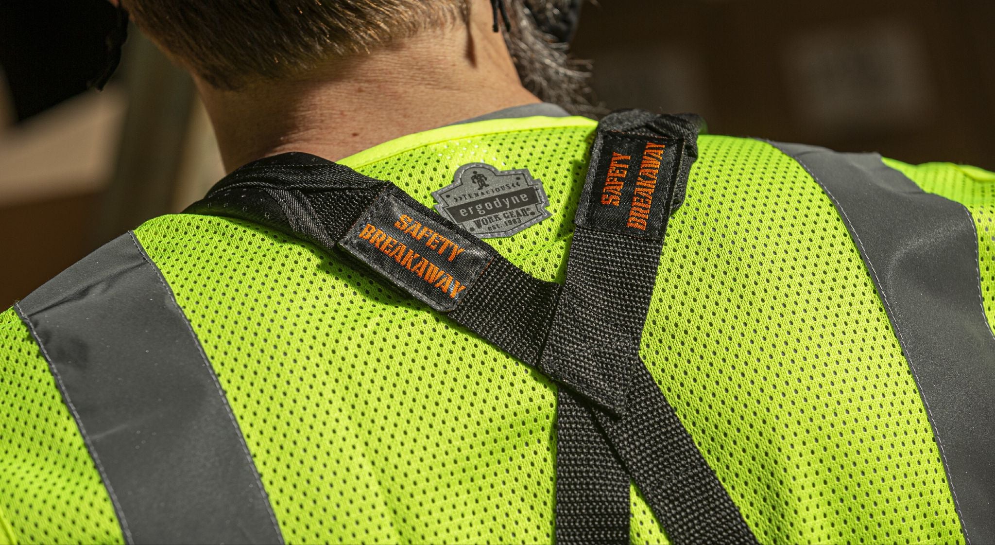 Safety breakaway straps across the back of a worker