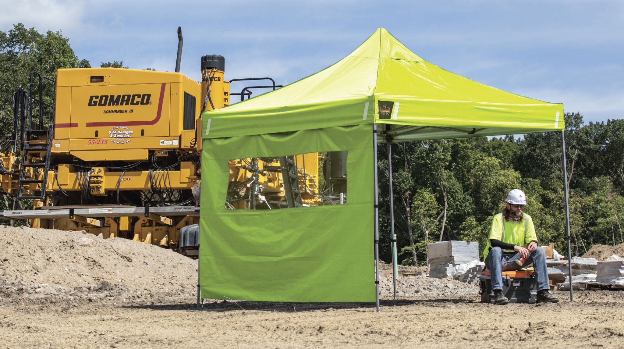 Worker taking a break underneath a SHAX pop-up tent