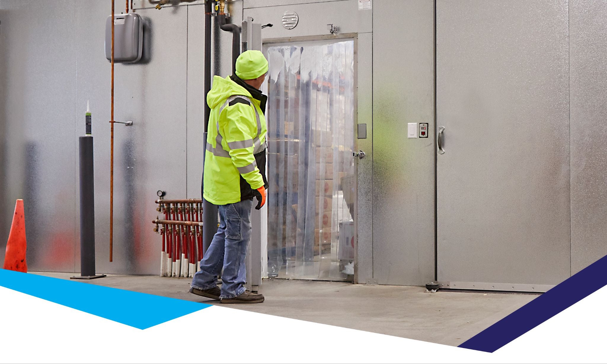 Worker entering a cold storage freezer