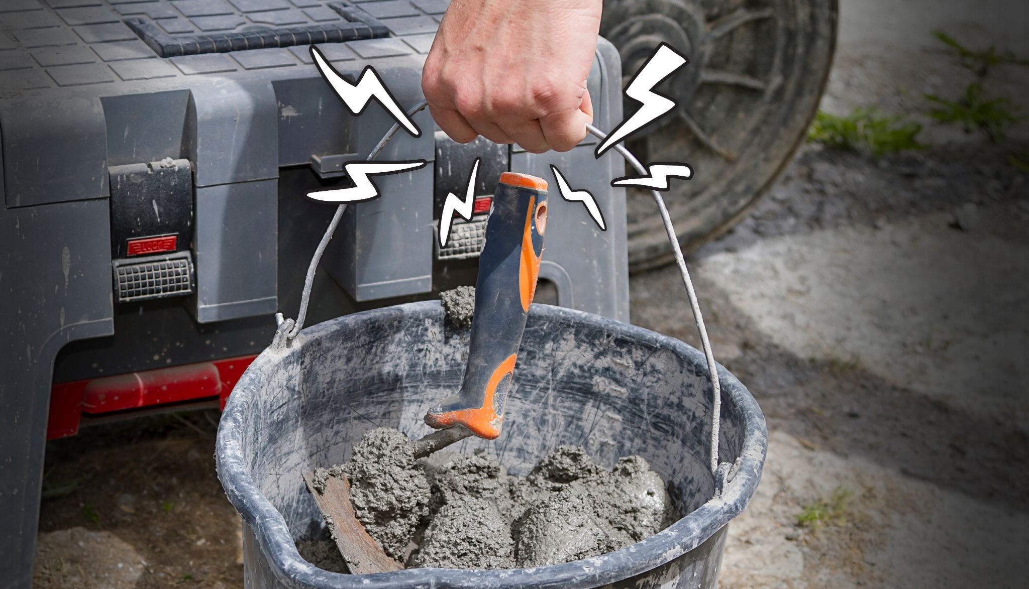Hand holding the metal handle of a heavy 5-gallon bucket