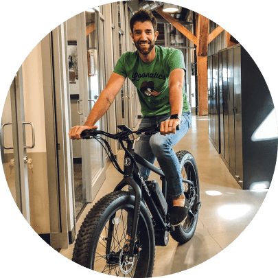 Ergodyne employee riding bicycle indoors