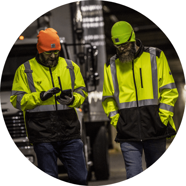 Two workers in lightweight hi-vis jackets