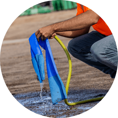 Person wetting an evaporative cooling towel