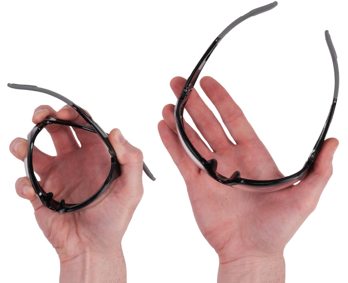 Two hands squeezing a pair of nylon Skullerz Safety Glasses to demonstrate their flexible frames