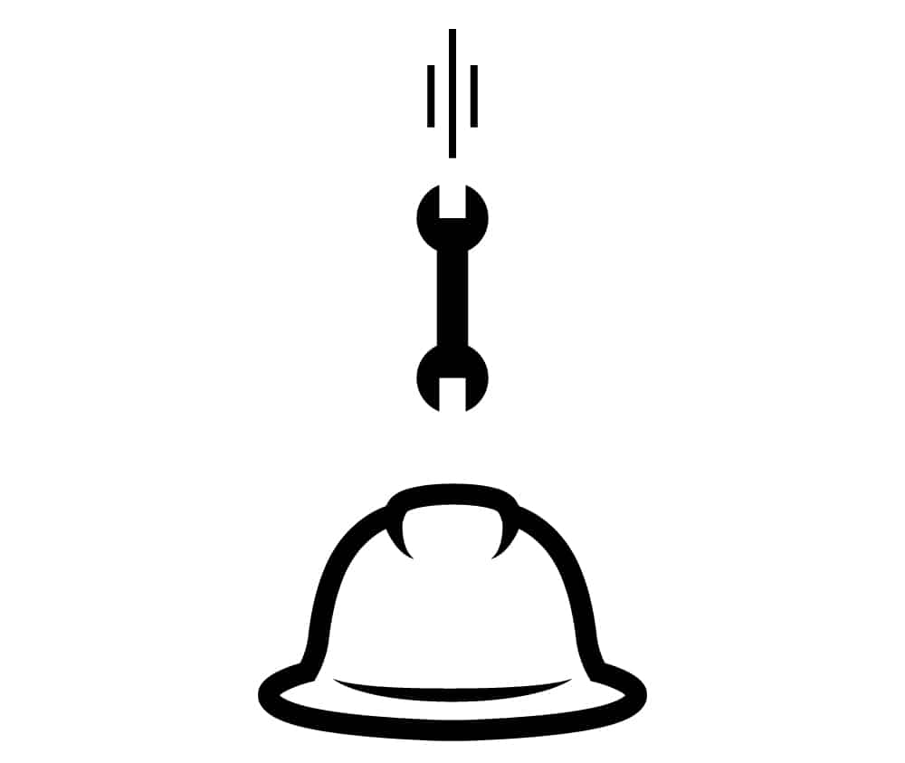 Wrench falling straight down onto a hard hat