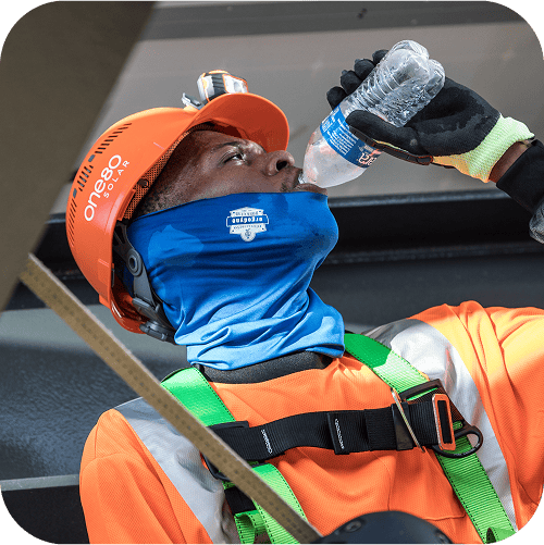 Working sweating on the jobsite chugging a bottle of water