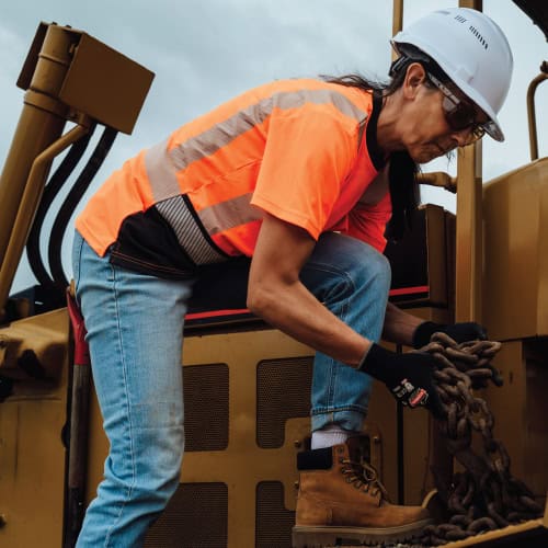 Woman mechanic working on airplane in GloWear Women's Fit Hi-Vis shirt