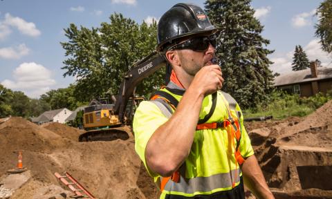 Worker drinking from hydration pack