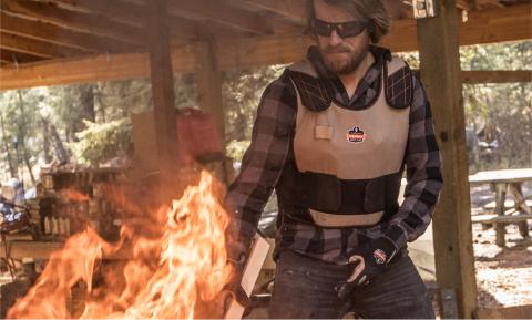 Man wearing cooling vest using fire kiln 