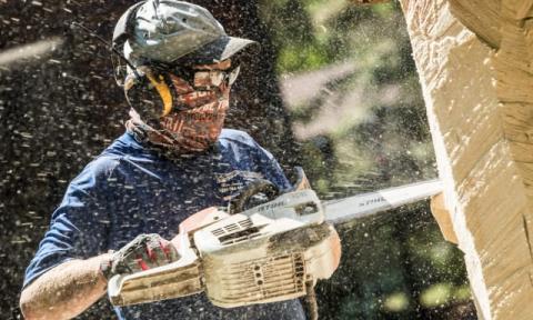 Cutting with a chainsaw but protected from danger