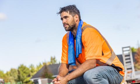 Worker wearing cooling towel in the heat