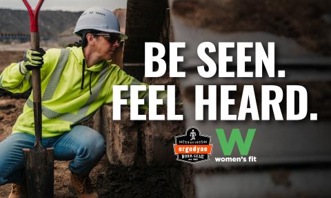 Woman worker on a construction site. Text on picture is Be Seen. Feel Heard. Women's Fit.