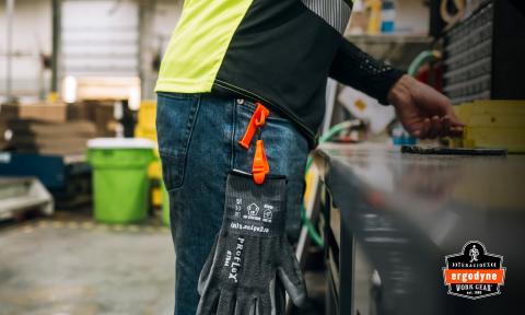 Worker wearing a belt clip glove holder