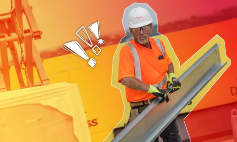 Worker holding construction paneling in hazy heat conditions