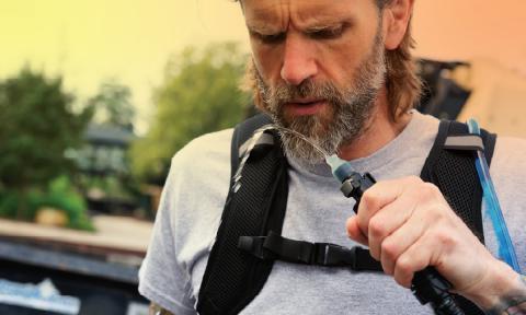 Worker drinking water from a hydration pack