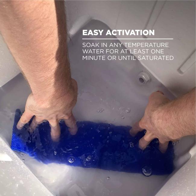 Easy activation: soak in any temperature water for at least one minute or until fully saturated. Image shows person putting towel into cooler full of water