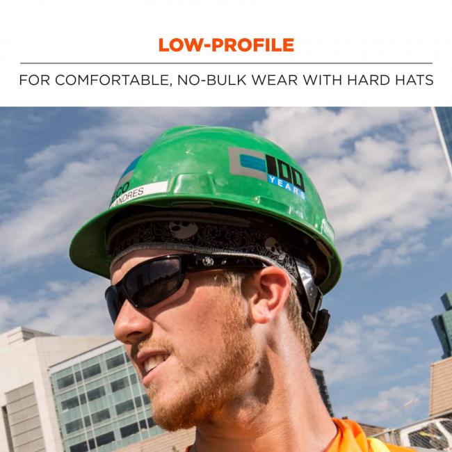 Low-profile: for comfortable, no-bulk wear with hard hats. Image shows worker wearing headband under hard hat. 
