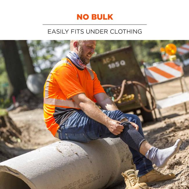 No bulk: easily fits under clothing. Image shows construction worker putting on under clothing. 