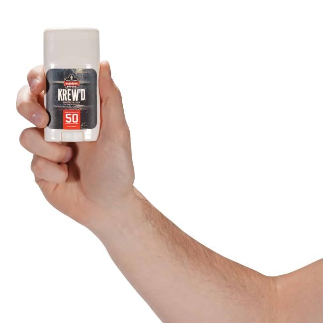 hand holding sunscreen stick