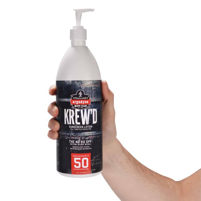 bottle of sunscreen in hand