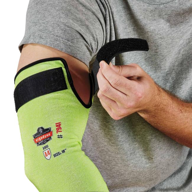 man adjusting sleeve on upper arm