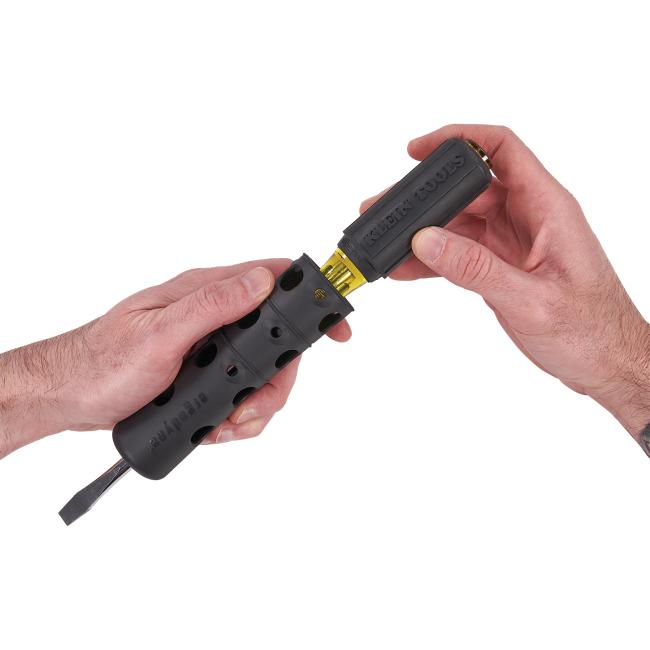 Screwdriver inserted into tool grip and tether attachment