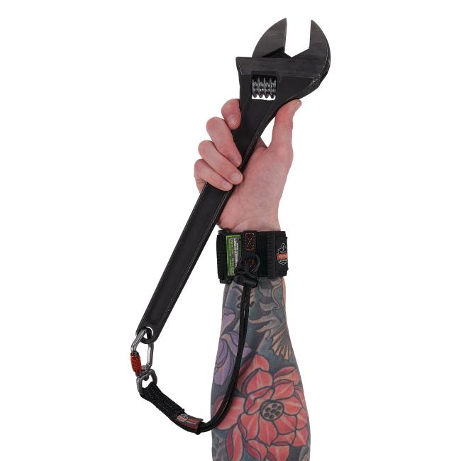 elastic tool tail lanyard attached to a wrench using the carabiner end and a tool wristband