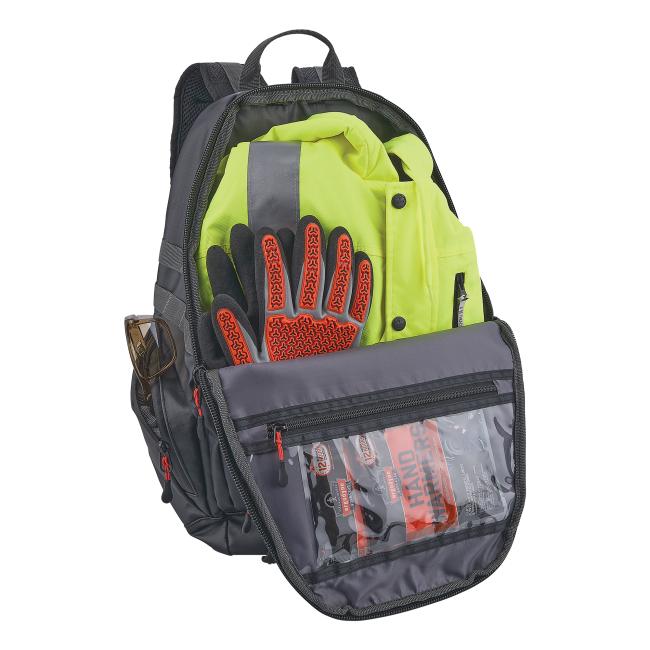 Open gray backpack showing neon yellow safety jacket, black gloves with red textured grips, sunglasses in side pocket and clear pouch with packaged items
