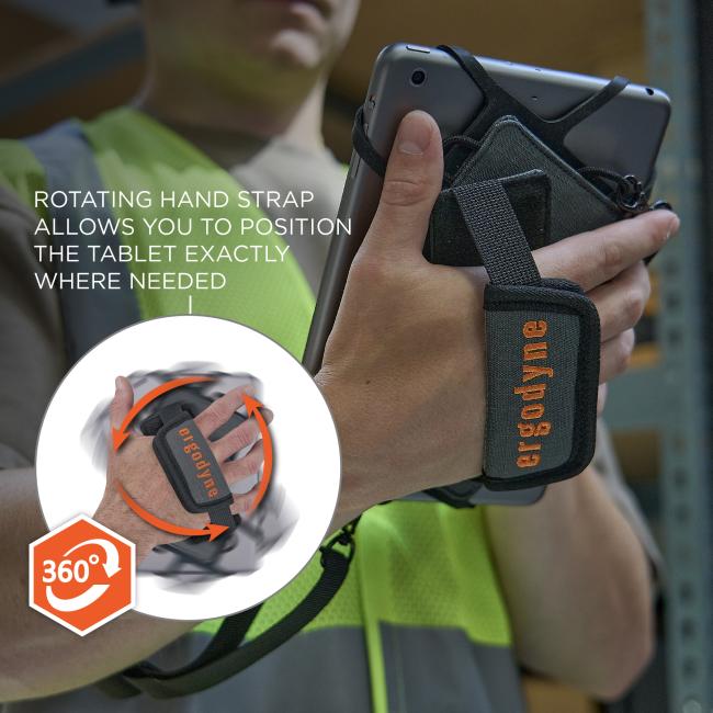 Close-up of a person in a hi-vis vest holding a tablet secured by a black fabric rotating hand strap around their hand.