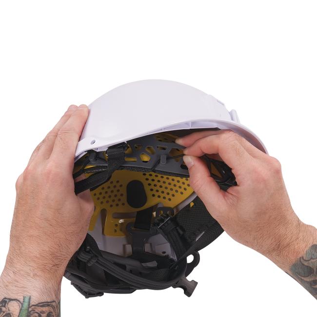 Detail picture of sweatbands being inserted into safety helmet.
