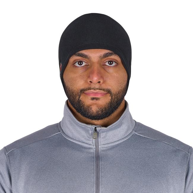 Close-up of a man's face wearing a black fitted head covering and a gray zip-up jacket, showing eyes and beard.