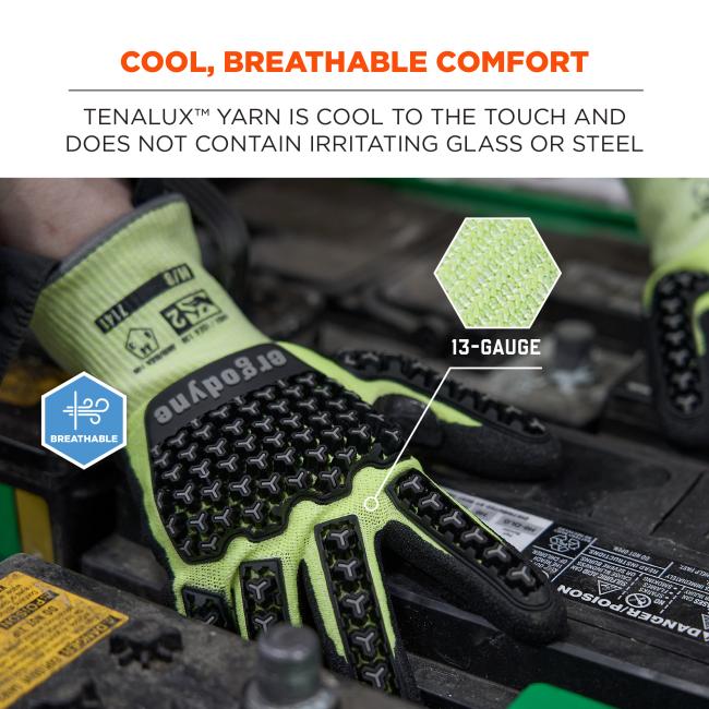 High-visibility lime green work glove with black textured rubber grips resting on engine components, breathable badge and fabric inset.