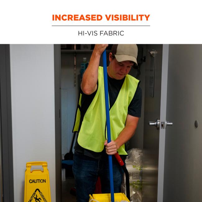 Person wearing fluorescent yellow safety vest mopping with a blue handle and yellow mop bucket, wet-floor caution sign visible