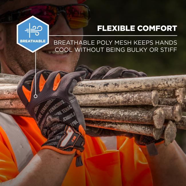 Close-up of person in orange safety shirt wearing gray-orange work gloves gripping stacked metal pipes; blue "BREATHABLE" badge visible