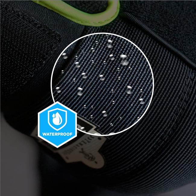 Close-up of black textured fabric with water droplets in a white circular magnifier, green fabric trim and blue waterproof badge.