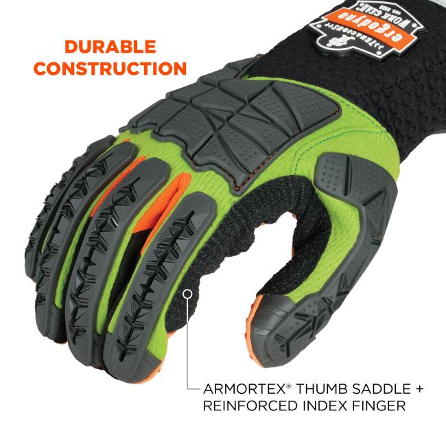 Close-up of green and black protective glove with gray segmented rubber finger and knuckle guards, orange accents, and "DURABLE CONSTRUCTION" text