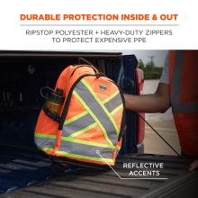 Orange high-visibility backpack with reflective gray and neon-yellow X accents in a pickup truck bed, worker's arm in an orange safety vest visible.