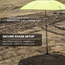 Lime-green umbrella canopy on a metal pole with cross-shaped base set on rough dirt, white text overlay visible