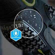 Close-up of shoe textured fabric and patterned rubber sole with water droplets, magnified circular inset, neon yellow accent and partial waterproof badge