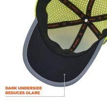 Close-up of cap interior: dark brim with gray edge, neon green polka-dot lining and black crossed inner straps with orange accents
