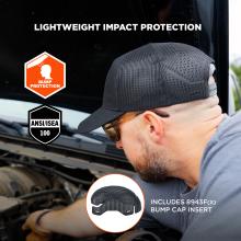 Man in black mesh baseball cap and safety glasses leaning over a vehicle engine; orange bump protection icon and ANSI/ISEA shield visible