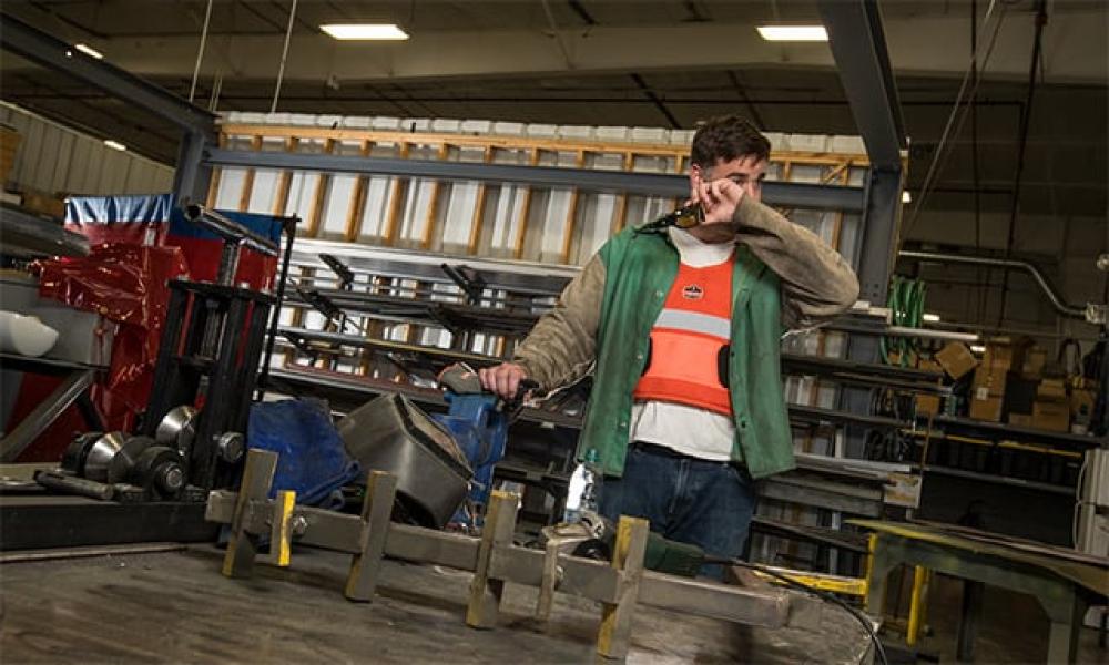 Welder with an orange phase change vest