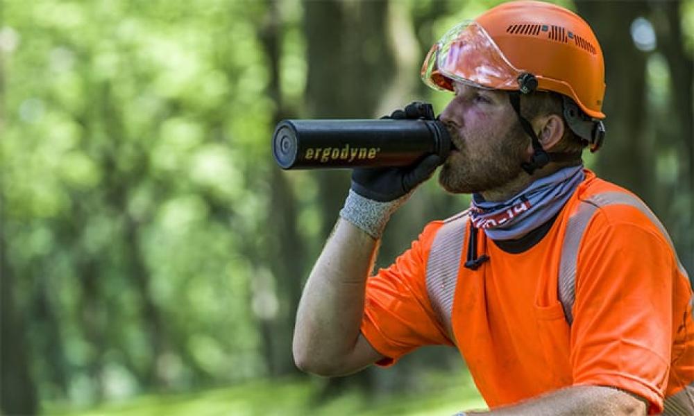 Hi vis orange shirt with water bottle to stay hydrated